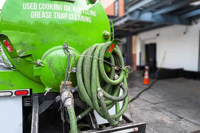 a professional technician pumping a restaurant's grease trap in North Judson